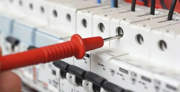Electrical contractor testing circuit breakers during electrical repair in Eagle, ID