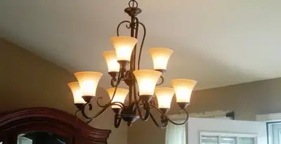 Classic ceiling chandelier installation with warm lighting in Boise, ID