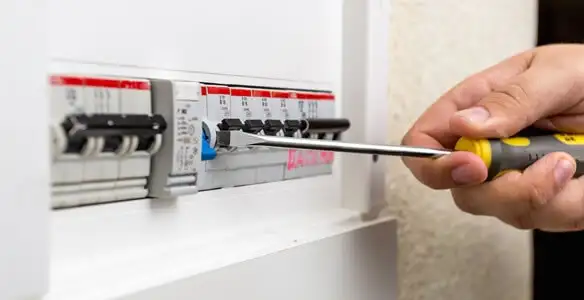 electrical panel upgrade service showing technician adjusting circuit breakers during system upgrade in Boise, ID