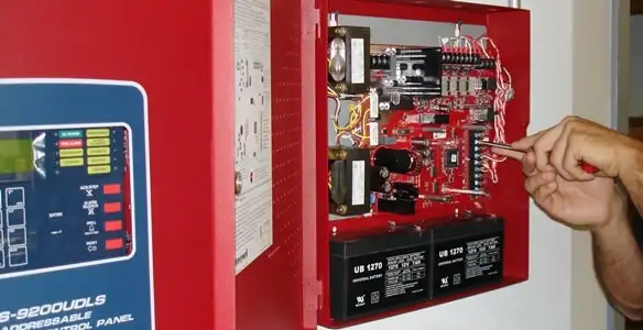 fire alarm installation service showing technician configuring fire alarm control panel in Boise, ID