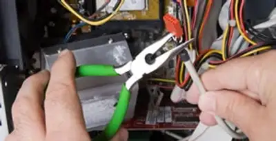 Licensed electrical contractor performing electrical repair with tools in Middleton, ID