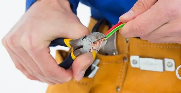 licensed electrician securing electrical wiring with professional tools during service work in Boise, ID