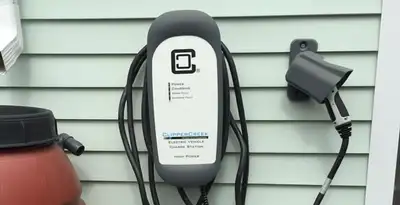 Outdoor electric vehicle charger installation on residential wall in Boise, ID