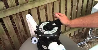 pool pumps service showing professional adjustment of pool pump control system in Boise, ID